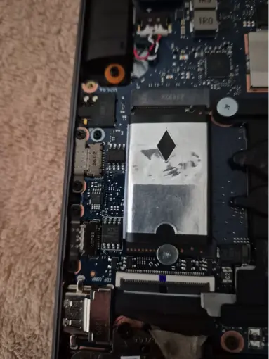 Laptop motherboard with M.2 SSD internal components during upgrade