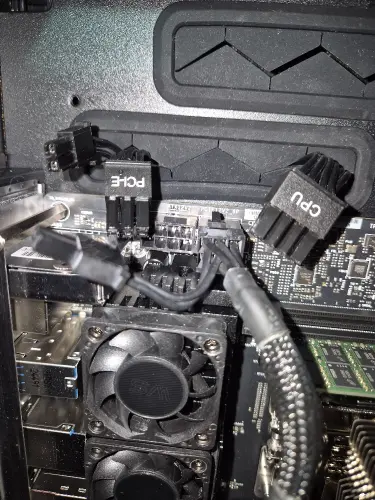 PC motherboard with CPU and PCIe power connectors installed during desktop computer repair